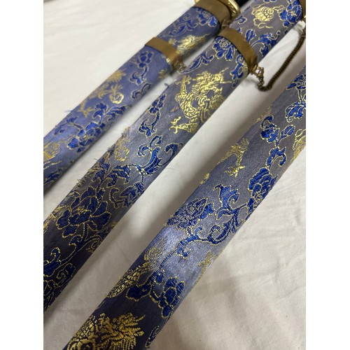 1225 - A set of three blue dragon Kitana swords decorated in blue and gold fabric (3).