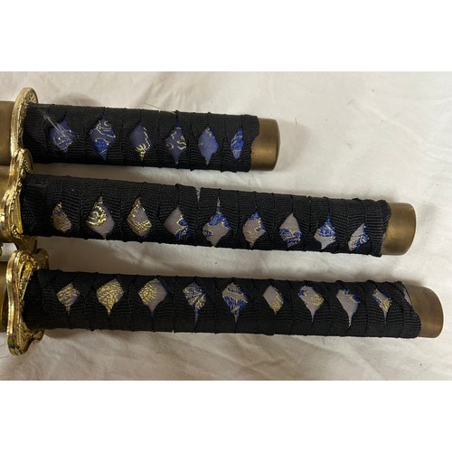 1225 - A set of three blue dragon Kitana swords decorated in blue and gold fabric (3).