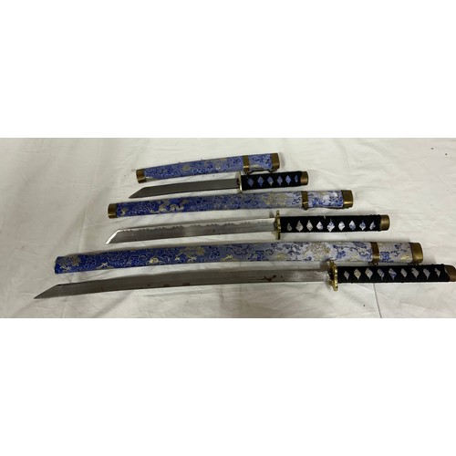 1225 - A set of three blue dragon Kitana swords decorated in blue and gold fabric (3).