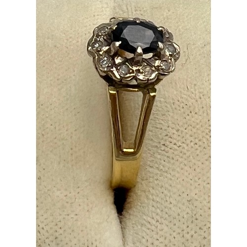 586 - An 18 carat gold sapphire and diamond cluster ring with fork shoulders. Size R. Weight 3.8gm.