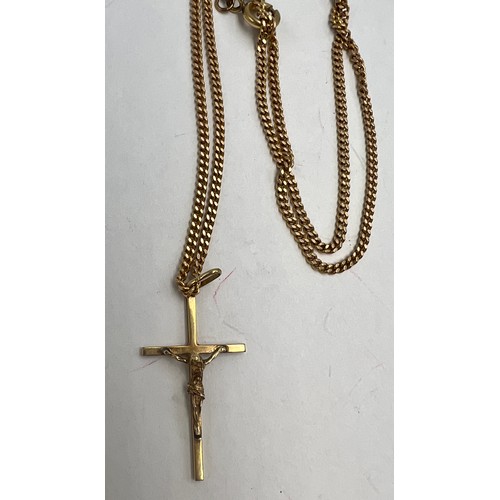 587 - A 9 carat gold chain with crucifix. Chain 60cm length. Weight 8.1gm.