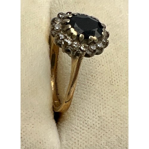 594 - A 9 carat gold blue and clear stone cluster ring. Size J/K. Weight 2gm.