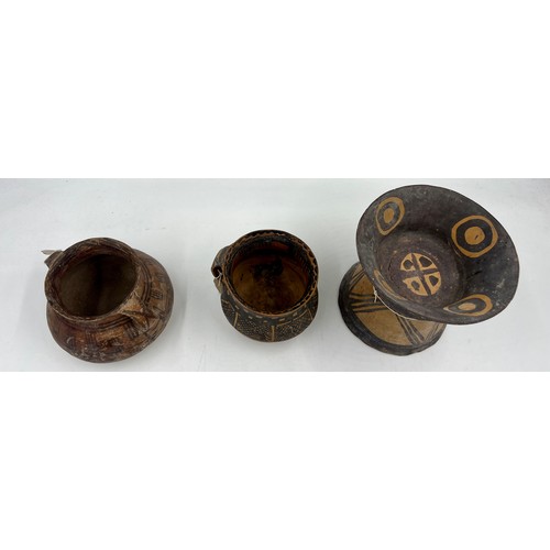 943 - Three Chinese Neolithic vessels to include a flared tazza, a single handled cup and twin handled bow... 