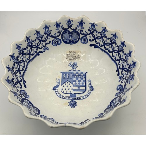 133 - An early 19th century blue and white transfer printed Spode armorial fruit bowl, c. 1825. It has a D... 