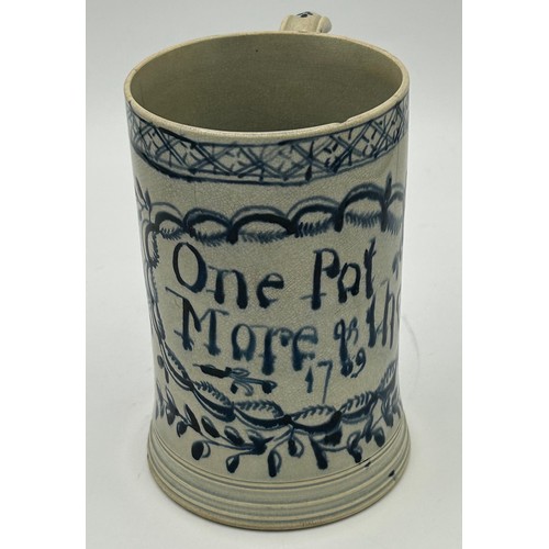 147 - An 18th century blue and white hand-painted pearlware dated mug, c. 1769. With 