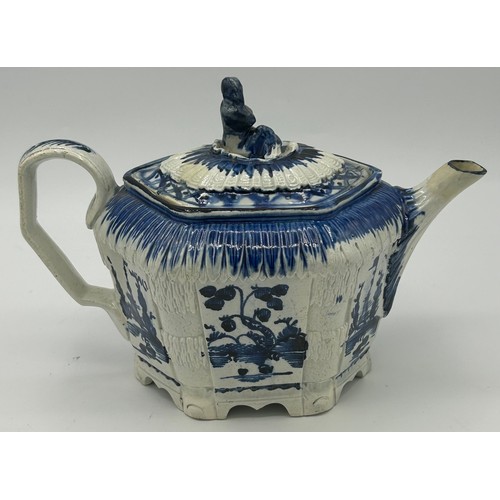 151 - A late 18th century blue and white hand-painted pearlware moulded teapot and cover, decorated with c... 