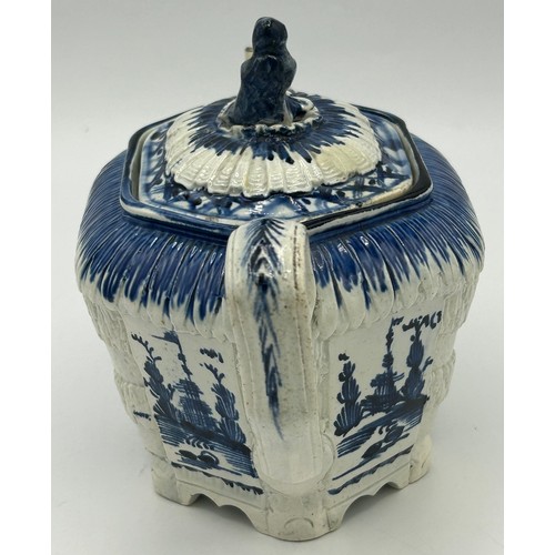 151 - A late 18th century blue and white hand-painted pearlware moulded teapot and cover, decorated with c... 