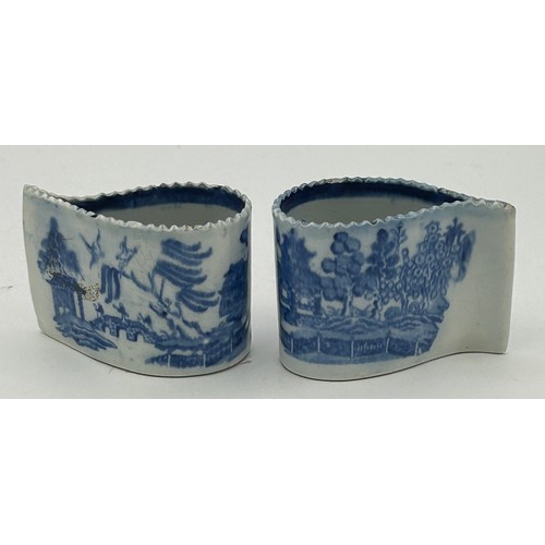 168 - Two early 19th century pearlware blue and white transfer printed willow pattern comma cups, c. 1810.... 