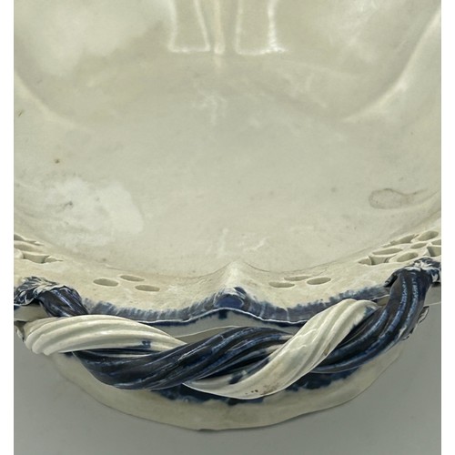 176 - An early 19th century hand-painted pearlware blue and white shell edge footed comport with rope-twis... 