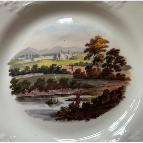 184 - A group of early 19th century hand-painted porcelain plates, of moulded form with titled Indian view... 