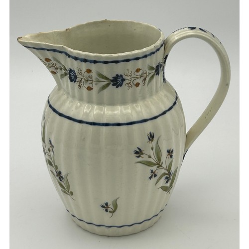 215 - A group of three early 19th century hand-painted pearlware floral pattern jugs, c. 1810-20. Tallest:... 