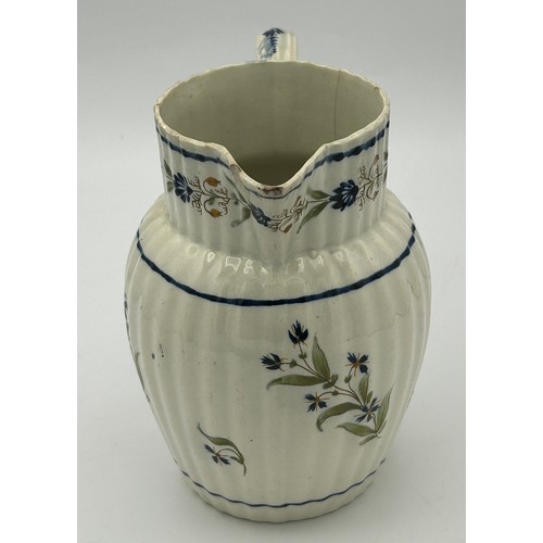 215 - A group of three early 19th century hand-painted pearlware floral pattern jugs, c. 1810-20. Tallest:... 