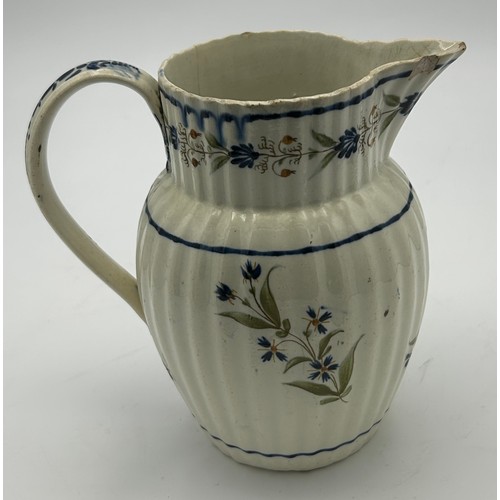 215 - A group of three early 19th century hand-painted pearlware floral pattern jugs, c. 1810-20. Tallest:... 