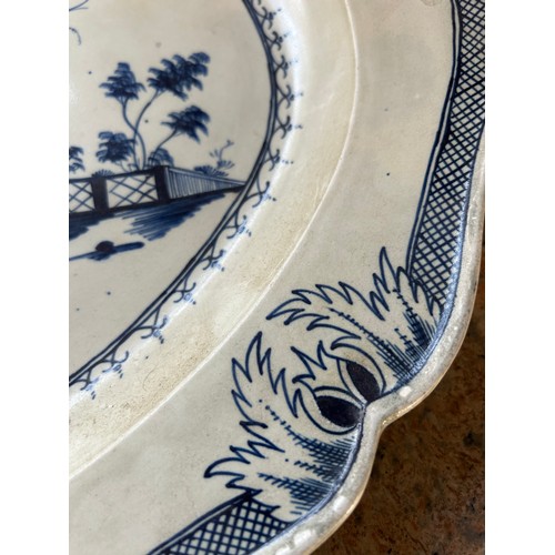 220 - An early 19th century hand-painted pearlware landscape pattern moulded rim platter, c. 1810. 48cm wi... 