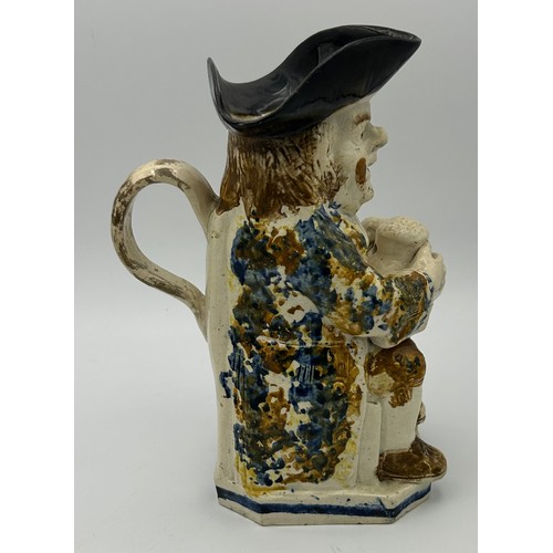 226 - A late 18th century Staffordshire toby jug, decorated in Pratt colours, c. 1780. 24 cm tall. (1)

Co... 