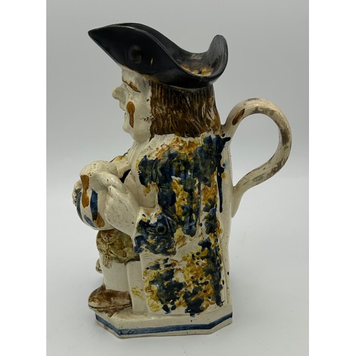 226 - A late 18th century Staffordshire toby jug, decorated in Pratt colours, c. 1780. 24 cm tall. (1)

Co... 