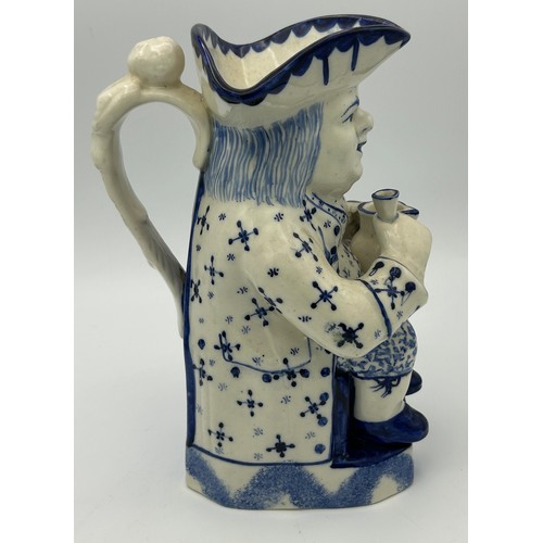 227 - A late 19th century Staffordshire toby jug, decorated in blue and white, c. 1900. 26 cm tall. (1)

C... 