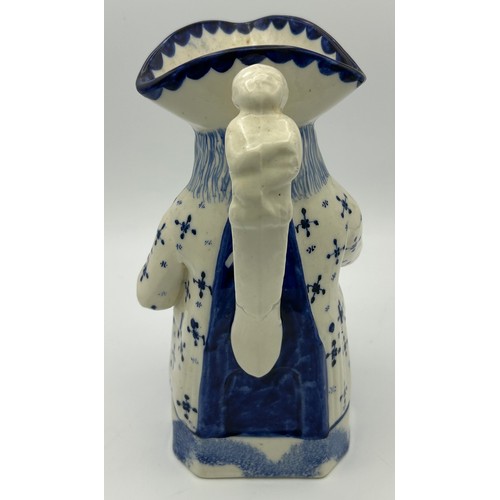 227 - A late 19th century Staffordshire toby jug, decorated in blue and white, c. 1900. 26 cm tall. (1)

C... 