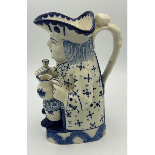 227 - A late 19th century Staffordshire toby jug, decorated in blue and white, c. 1900. 26 cm tall. (1)

C... 