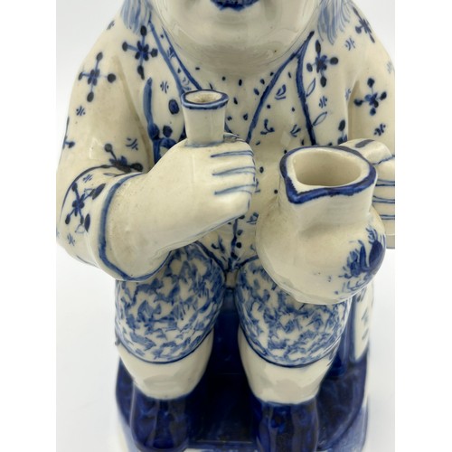 227 - A late 19th century Staffordshire toby jug, decorated in blue and white, c. 1900. 26 cm tall. (1)

C... 