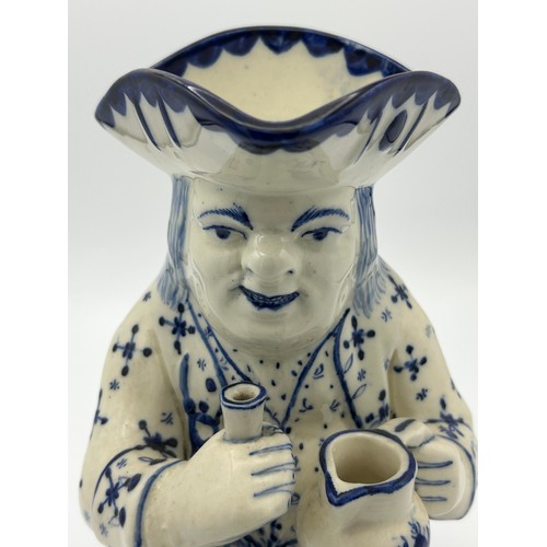 227 - A late 19th century Staffordshire toby jug, decorated in blue and white, c. 1900. 26 cm tall. (1)

C... 