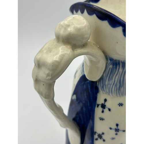 227 - A late 19th century Staffordshire toby jug, decorated in blue and white, c. 1900. 26 cm tall. (1)

C... 