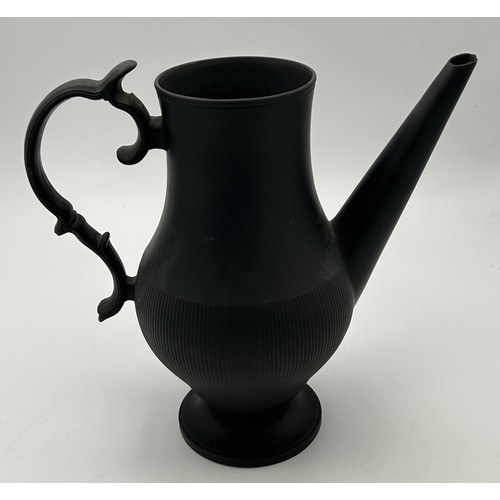 241 - A group of early 19th century black basalt wares, c. 1810. To include two teapots with lion knops, a... 