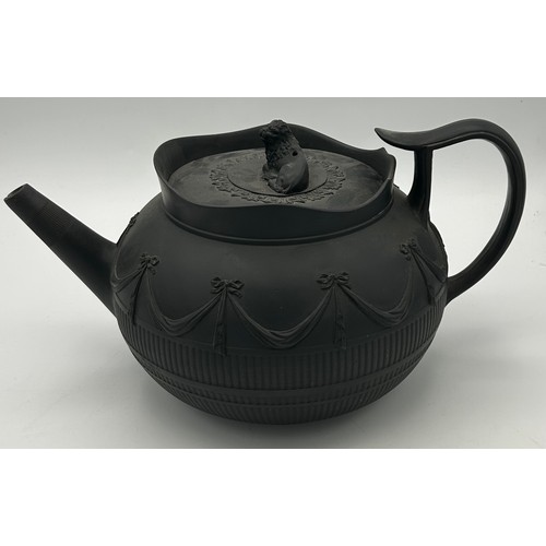 241 - A group of early 19th century black basalt wares, c. 1810. To include two teapots with lion knops, a... 