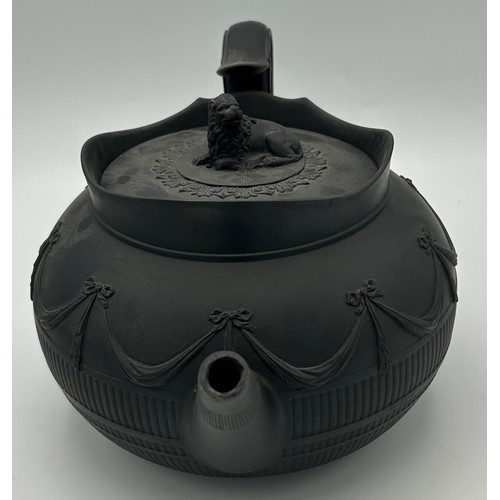 241 - A group of early 19th century black basalt wares, c. 1810. To include two teapots with lion knops, a... 