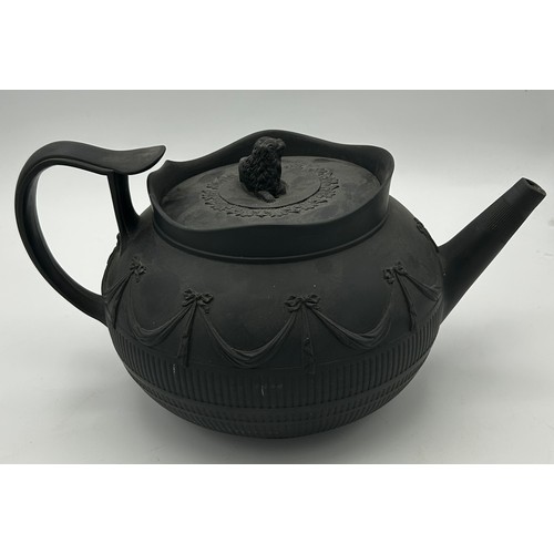 241 - A group of early 19th century black basalt wares, c. 1810. To include two teapots with lion knops, a... 