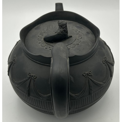 241 - A group of early 19th century black basalt wares, c. 1810. To include two teapots with lion knops, a... 