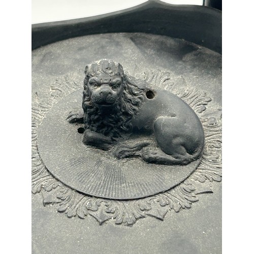 241 - A group of early 19th century black basalt wares, c. 1810. To include two teapots with lion knops, a... 