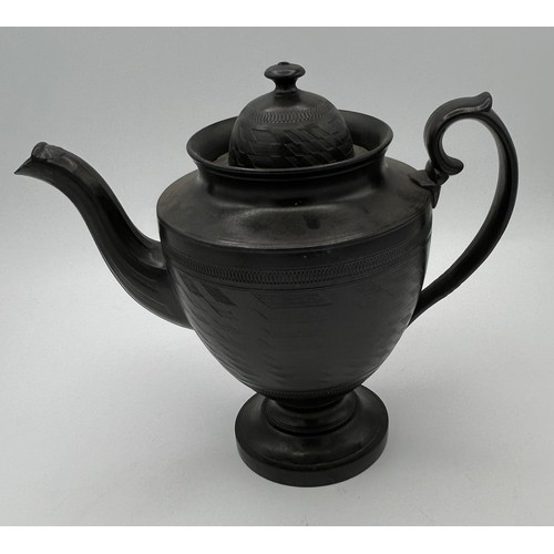 241 - A group of early 19th century black basalt wares, c. 1810. To include two teapots with lion knops, a... 