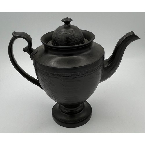 241 - A group of early 19th century black basalt wares, c. 1810. To include two teapots with lion knops, a... 