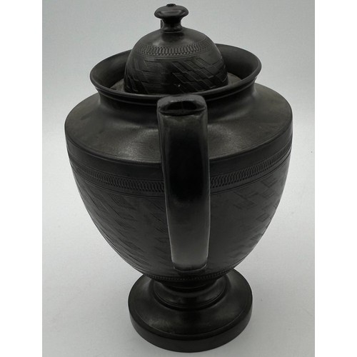 241 - A group of early 19th century black basalt wares, c. 1810. To include two teapots with lion knops, a... 