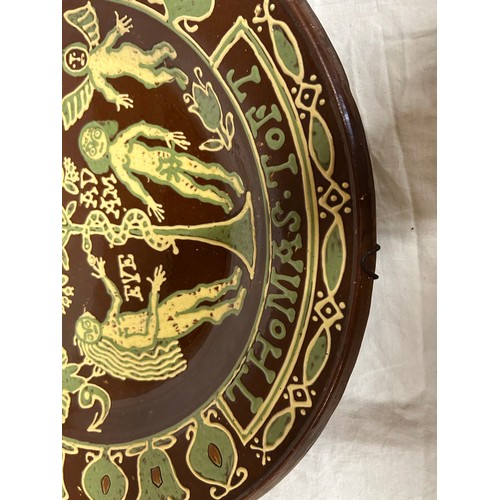 245 - A large and impressive slip trailed Adam and Eve terracotta charger, after Thomas Toft. 45 cm wide. ... 