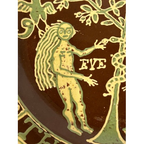 245 - A large and impressive slip trailed Adam and Eve terracotta charger, after Thomas Toft. 45 cm wide. ... 