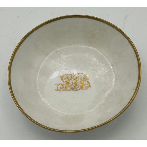 287 - An early 19th century Spode white porcelain and gilded dedicated small cup and saucer, c. 1820. Poss... 