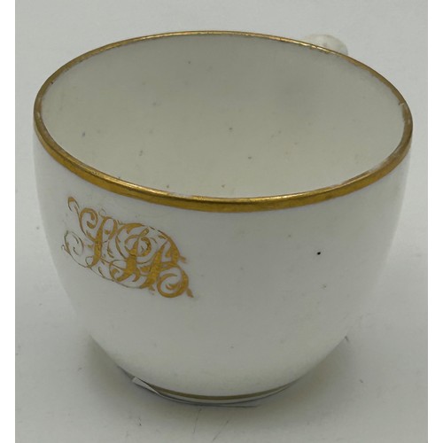 287 - An early 19th century Spode white porcelain and gilded dedicated small cup and saucer, c. 1820. Poss... 