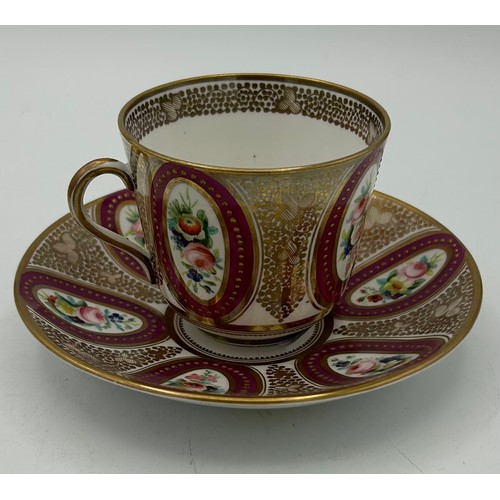 299 - Two early 19th century hand-painted porcelain cups and saucers with raised gilding and floral vignet... 