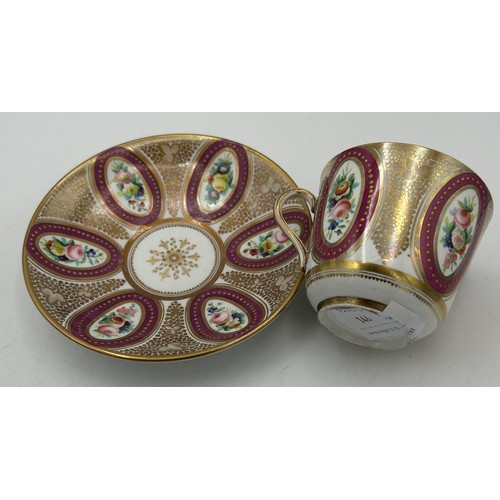 299 - Two early 19th century hand-painted porcelain cups and saucers with raised gilding and floral vignet... 