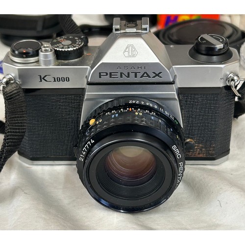 965 - An Asahi Pentax K1000 SLR camera with a 50mm lens with camera case together with Makinon 24mm lens i... 