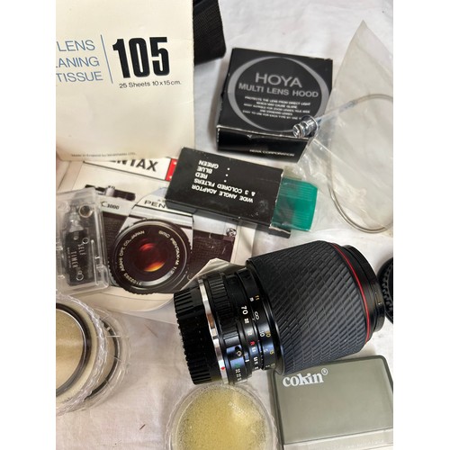 965 - An Asahi Pentax K1000 SLR camera with a 50mm lens with camera case together with Makinon 24mm lens i... 