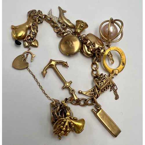 606 - A charm bracelet with multiple charms. Bracelet marked 9 carat, most charms unmarked.  Total weight ... 