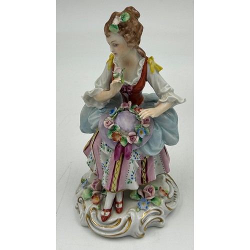 433 - A Sitzendorf lady with a flowered hat together with two Capodimonte figurines of lady with flowers a... 