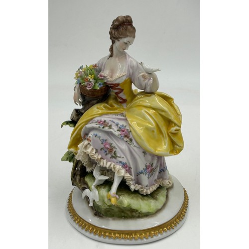 433 - A Sitzendorf lady with a flowered hat together with two Capodimonte figurines of lady with flowers a... 