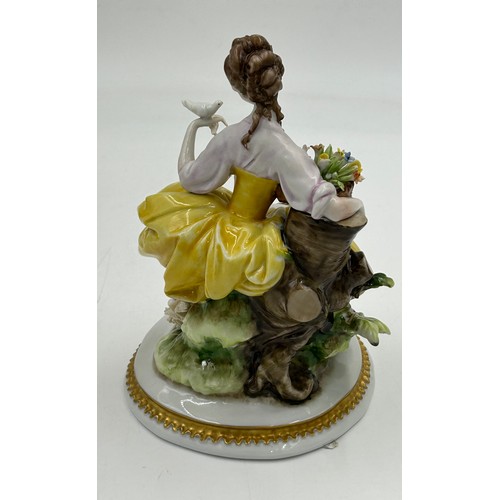 433 - A Sitzendorf lady with a flowered hat together with two Capodimonte figurines of lady with flowers a... 