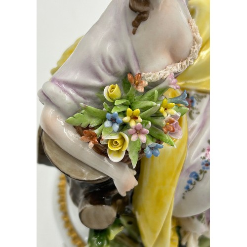 433 - A Sitzendorf lady with a flowered hat together with two Capodimonte figurines of lady with flowers a... 