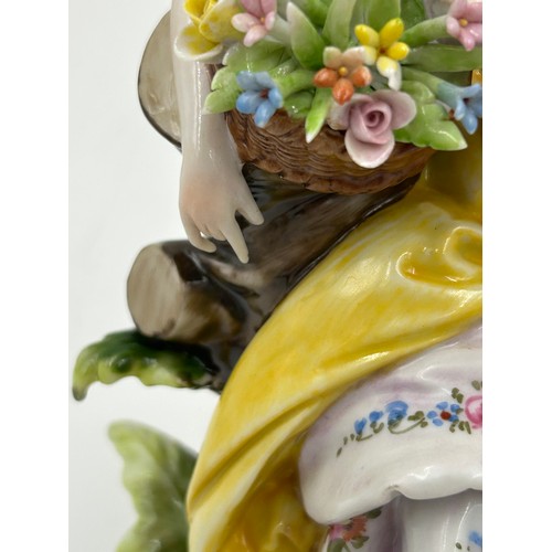 433 - A Sitzendorf lady with a flowered hat together with two Capodimonte figurines of lady with flowers a... 