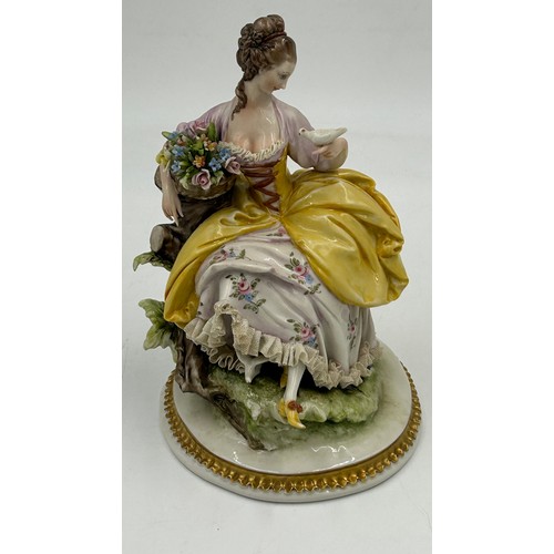 433 - A Sitzendorf lady with a flowered hat together with two Capodimonte figurines of lady with flowers a... 